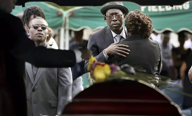 FILE - Tyrone Sanders and Felicia Sanders comfort each other at the graveside of their son, Tywanza Sanders, on June 27, 2015, at Emanuel AME Cemetery in Charleston, S.C. (Grace Beahm/The Post And Courier via AP, File)