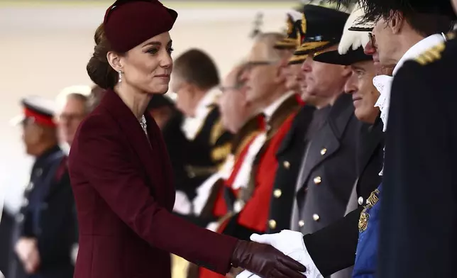 Britain's Kate, Princess of Wales arrives to welcome the Emir of the State of Qatar Sheikh Tamim bin Hamad Al Thani and Sheikha Jawaher bint Hamad bin Suhaim Al Thani in London, Tuesday, Dec. 3, 2024. (Henry Nicholls, Pool via AP)