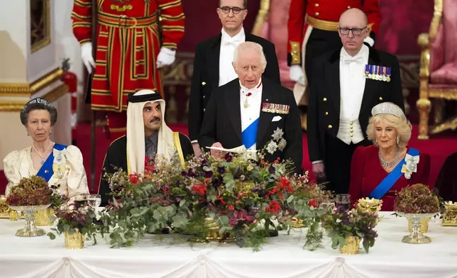 Britain's King Charles III, centre, and Queen Camilla, right, with the Emir of Qatar Sheikh Tamim bin Hamad Al Thani, second left, and Britain's Princess Anne, left, during a State Banquet at Buckingham Palace, in London, Tuesday, Dec. 3, 2024, during the state visit to the U.K. of the Emir of Qatar. (Jordan Pettitt/Pool Photo via AP)