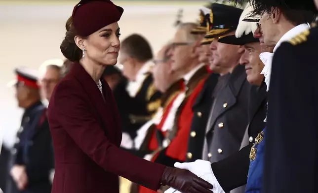 Britain's Catherine, Princess of Wales, greets dignitaries as she arrives ahead of a Ceremonial Welcome for the Emir of Qatar Sheikh Tamim bin Hamad Al Thani and his wife Sheikha Jawaher, at Horse Guards Parade in London, Tuesday Dec. 3, 2024. (Henry Nicholls via AP, Pool)