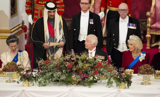 Britain's King Charles III, centre, and Queen Camilla, right, with the Emir of Qatar Sheikh Tamim bin Hamad Al Thani, second left, and Britain's Princess Anne, left, during a State Banquet at Buckingham Palace, in London, Tuesday, Dec. 3, 2024, during the state visit to the U.K. of the Emir of Qatar and the first of his three wives. (Jordan Pettitt/Pool Photo via AP)