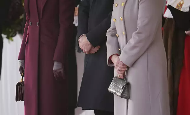 Britain's Kate, Princess of Wales, Prince William and Sheikha Jawaher bint Hamad bin Suhaim Al Thani smile during the ceremonial welcome in London, Tuesday, Dec. 3, 2024. (AP Photo/Kin Cheung, Pool)