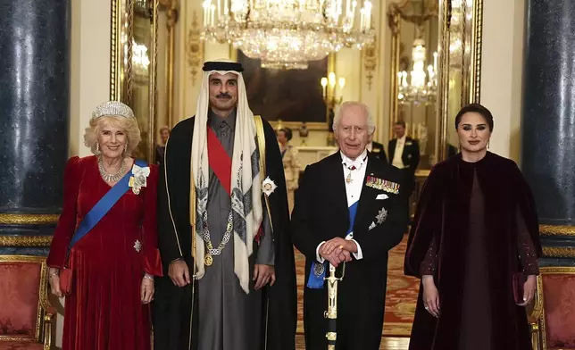 Britain's King Charles III, second right, and Queen Camilla, left, with the Emir of Qatar Sheikh Tamim bin Hamad Al Thani and his wife Sheikha Jawaher ahead of a state banquet at Buckingham Palace, in London, Tuesday, Dec. 3, 2024, during his state visit to the U.K. (Aaron Chown/Pool Photo via AP)