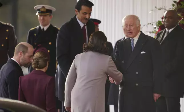 Britain's Kate, Princess of Wales, Prince William, front left, and King Charles III, right, welcome the Emir of the State of Qatar Sheikh Tamim bin Hamad Al Thani and Sheikha Jawaher bint Hamad bin Suhaim Al Thani in London, Tuesday, Dec. 3, 2024. (AP Photo/Kin Cheung, Pool)