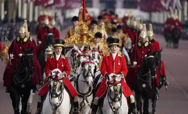 A carriage procession along The Mall to welcome the Emir of the State of Qatar Sheikh Tamim bin Hamad Al Thani and Sheikha Jawaher bint Hamad bin Suhaim Al Thani in London, Tuesday, Dec. 3, 2024. (AP Photo/Alberto Pezzali)