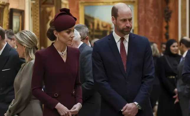 Britain's Catherine, Princess of Wales stands next to Prince William, Prince of Wales, as Qatari Emir Sheikh Tamim bin Hamad al-Thani and his wife Sheikha Jawaher bint Hamad bin Suhaim Al-Thani visit Buckingham palace in London, Britain, Tuesday, Dec. 3, 2024. (Mina Kim/Pool via AP)