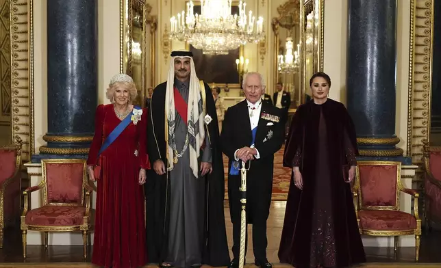 Britain's King Charles III, second right, and Queen Camilla, left, with the Emir of Qatar Sheikh Tamim bin Hamad Al Thani and his wife Sheikha Jawaher ahead of a state banquet at Buckingham Palace, in London, Tuesday, Dec. 3, 2024, during his state visit to the U.K. (Aaron Chown/Pool Photo via AP)