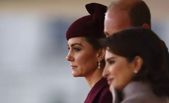 Britain's Kate, Princess of Wales and Prince William arrive to welcome the Emir of the State of Qatar Sheikh Tamim bin Hamad Al Thani and Sheikha Jawaher bint Hamad bin Suhaim Al Thani, right, in London, Tuesday, Dec. 3, 2024. (Henry Nicholls, Pool via AP)