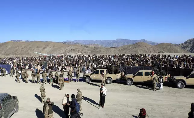 People attend the funeral prayer of Khalil Haqqani, the minister for refugees and repatriation, during his funeral procession in eastern Paktia province, Afghanistan, Thursday, Dec. 12, 2024. (AP Photo/Saifullah Zahir)