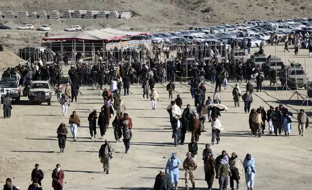 People attend the funeral prayer of Khalil Haqqani, the minister for refugees and repatriation, during his funeral procession in eastern Paktia province, Afghanistan, Thursday, Dec. 12, 2024. (AP Photo/Saifullah Zahir)