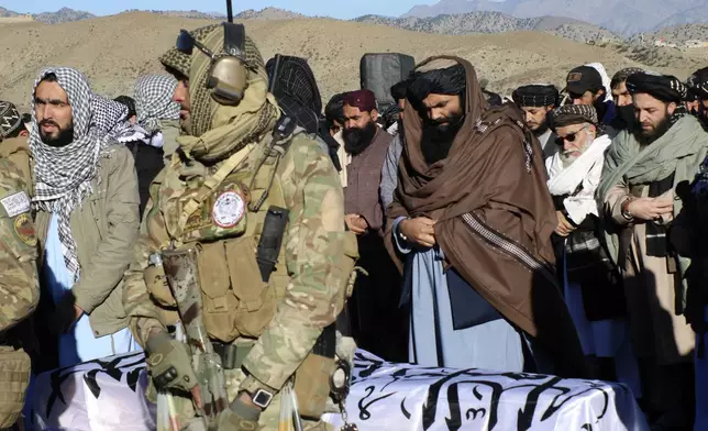 Acting interior minister Sirajuddin Haqqani, center, and mourners offer funeral prayers near the dead body of Khalil Haqqani, the minister for refugees and repatriation, during his funeral procession in eastern Paktia province, Afghanistan, Thursday, Dec. 12, 2024.(AP Photo/Saifullah Zahir)