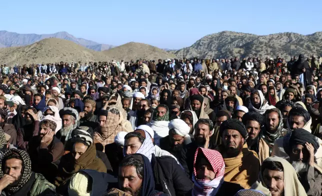 People attend the funeral prayer of Khalil Haqqani, the minister for refugees and repatriation, during his funeral procession in eastern Paktia province, Afghanistan, Thursday, Dec. 12, 2024. (AP Photo/Saifullah Zahir)