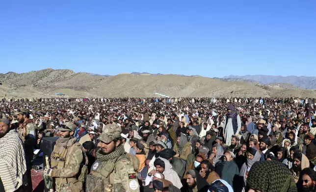 People attend the funeral prayer of Khalil Haqqani, the minister for refugees and repatriation, during his funeral procession in eastern Paktia province, Afghanistan, Thursday, Dec. 12, 2024. (AP Photo/Saifullah Zahir)