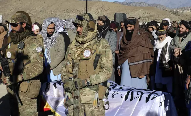 Acting interior minister Sirajuddin Haqqani, center, and mourners offer funeral prayers near the dead body of Khalil Haqqani, the minister for refugees and repatriation, during his funeral procession in eastern Paktia province, Afghanistan, Thursday, Dec. 12, 2024.(AP Photo/Saifullah Zahir)