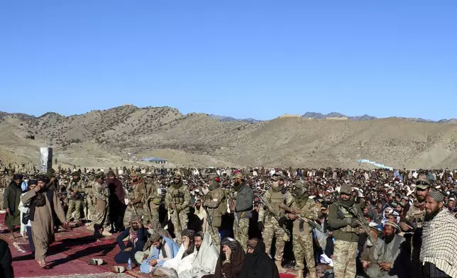 Taliban fighters stand guard during the funeral prayers of Khalil Haqqani, the minister for refugees and repatriation, during his funeral procession in eastern Paktia province, Afghanistan, Thursday, Dec. 12, 2024. (AP Photo/Saifullah Zahir)