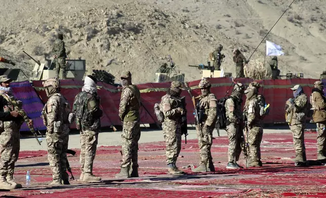 Taliban fighters stand guard during the funeral prayers of Khalil Haqqani, the minister for refugees and repatriation, during his funeral procession in eastern Paktia province, Afghanistan, Thursday, Dec. 12, 2024.(AP Photo/Saifullah Zahir)