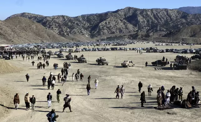 People attend the funeral prayer of Khalil Haqqani, the minister for refugees and repatriation, during his funeral procession in eastern Paktia province, Afghanistan, Thursday, Dec. 12, 2024.(AP Photo/Saifullah Zahir)