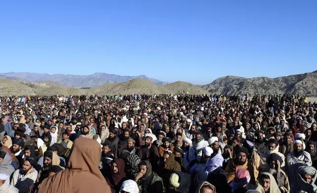 People attend the funeral prayer of Khalil Haqqani, the minister for refugees and repatriation, during his funeral procession in eastern Paktia province, Afghanistan, Thursday, Dec. 12, 2024. (AP Photo/Saifullah Zahir)