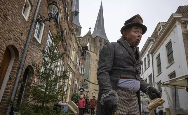 People in costumes from Charles Dickens' 19th-century English era take part in a Dickens Festival, in Deventer, Netherlands, Saturday, Dec. 14, 2024. (AP Photo/Peter Dejong)