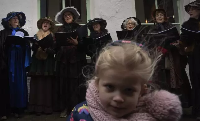 People in costumes from Charles Dickens' 19th-century English era sing, during a Dickens Festival, in Deventer, Netherlands, Saturday, Dec. 14, 2024. (AP Photo/Peter Dejong)