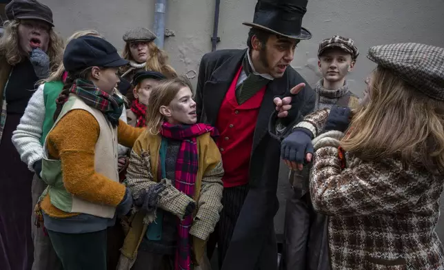 People in costumes from Charles Dickens' 19th-century English era take part in a Dickens Festival, in Deventer, Netherlands, Saturday, Dec. 14, 2024. (AP Photo/Peter Dejong)