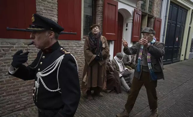 People in costumes from Charles Dickens' 19th-century English era take part in a Dickens Festival, in Deventer, Netherlands, Saturday, Dec. 14, 2024. (AP Photo/Peter Dejong)