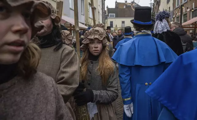 People in costumes from Charles Dickens' 19th-century English take part in a Dickens Festival, in Deventer, Netherlands, Saturday, Dec. 14, 2024. (AP Photo/Peter Dejong)