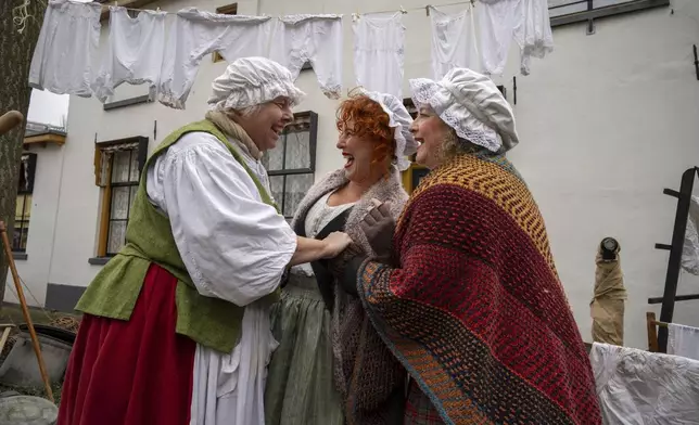 People in costumes from Charles Dickens' 19th-century English era take part in a Dickens Festival, in Deventer, Netherlands, Saturday, Dec. 14, 2024. (AP Photo/Peter Dejong)