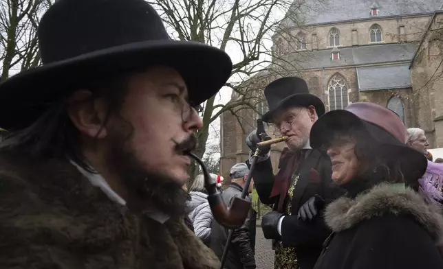 People in costumes from Charles Dickens' 19th-century English era take part in a Dickens Festival, in Deventer, Netherlands, Saturday, Dec. 14, 2024. (AP Photo/Peter Dejong)