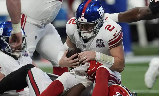 New York Giants quarterback Drew Lock (2) is sacked by Atlanta Falcons linebacker Arnold Ebiketie (17) in the first half of an NFL football game in Atlanta, Sunday, Dec. 22, 2024. (AP Photo/Mike Stewart)