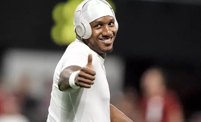 FILE - Atlanta Falcons quarterback Michael Penix Jr. warms up before an NFL football game between the Atlanta Falcons and the Kansas City Chiefs, Sunday, Sept. 22, 2024, in Atlanta. (AP Photo/Brynn Anderson, File)