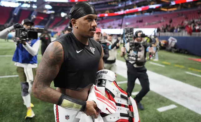 Atlanta Falcons quarterback Michael Penix Jr. (9) walk off the field after an NFL football game against the New York Giants in Atlanta, Sunday, Dec. 22, 2024. (AP Photo/Mike Stewart)