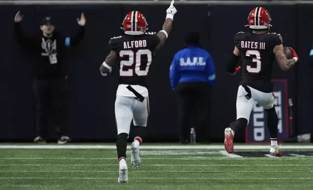 Atlanta Falcons safety Jessie Bates III (3) runs the ball in for a pick-6 in the first half of an NFL football game against the New York Giants in Atlanta, Sunday, Dec. 22, 2024. (AP Photo/John Bazemore)