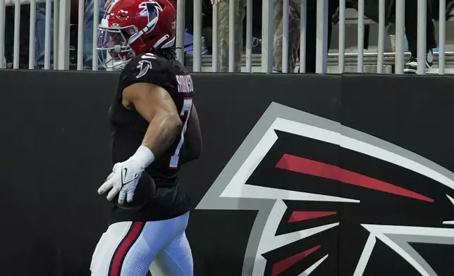 Atlanta Falcons running back Bijan Robinson (7) celebrates after a touchdown in the second half of an NFL football game against the New York Giants in Atlanta, Sunday, Dec. 22, 2024. (AP Photo/John Bazemore)