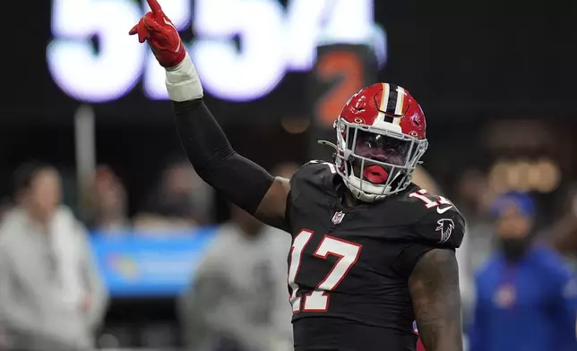 Atlanta Falcons linebacker Arnold Ebiketie (17) celebrates making a sack against New York Giants quarterback Drew Lock (2) in the first half of an NFL football game in Atlanta, Sunday, Dec. 22, 2024. (AP Photo/Mike Stewart)