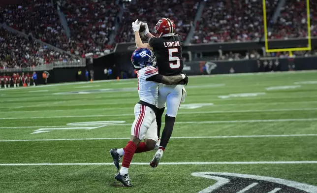 New York Giants cornerback Deonte Banks (3) breaks up a pass intended for Atlanta Falcons wide receiver Drake London (5) in the second half of an NFL football game in Atlanta, Sunday, Dec. 22, 2024. (AP Photo/John Bazemore)