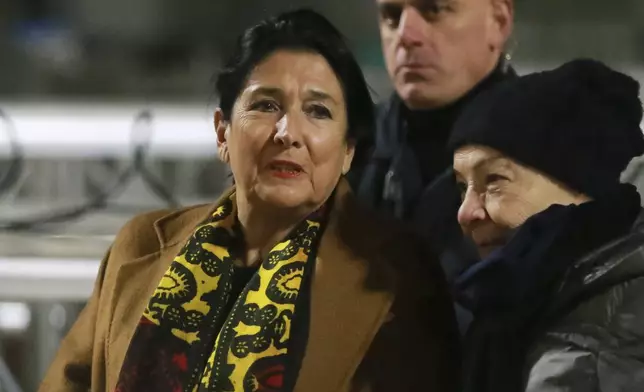 Georgian President Salome Zourabichvili, left, attends an anti-government rally outside the Parliament building in Tbilisi, Georgia, on Saturday, Dec. 14, 2024. (AP Photo/Zurab Tsertsvadze)