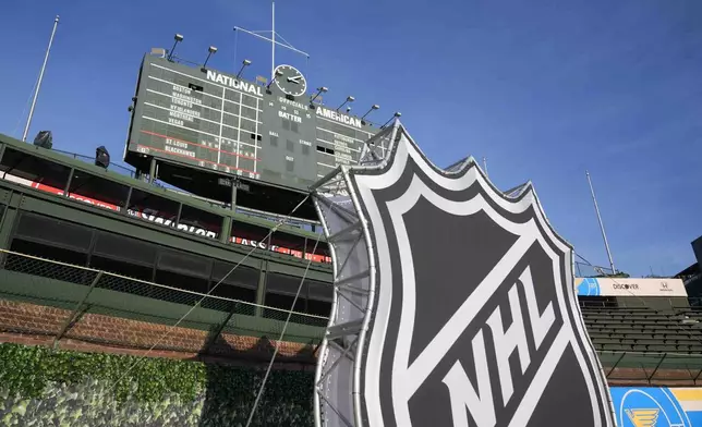 Preparations continue on the day before the NHL Winter Classic outdoor hockey game featuring the Chicago Blackhawks and the St. Louis Blues at Wrigley Field, Monday, Dec. 30, 2024, in Chicago. (AP Photo/Erin Hooley)