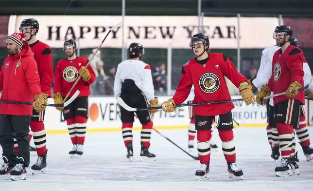 Chicago Blackhawks center Connor Bedard, second from right, skates during practice on the day before the NHL Winter Classic outdoor hockey game featuring the Blackhawks and the St. Louis Blues at Wrigley Field, Monday, Dec. 30, 2024, in Chicago. (AP Photo/Erin Hooley)