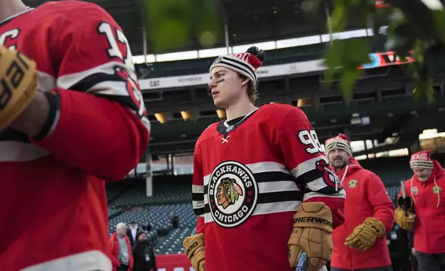 Chicago Blackhawks center Connor Bedard (98) takes the ice for practice on the day before the NHL Winter Classic outdoor hockey game featuring the Blackhawks and the St. Louis Blues at Wrigley Field, Monday, Dec. 30, 2024, in Chicago. (AP Photo/Erin Hooley)