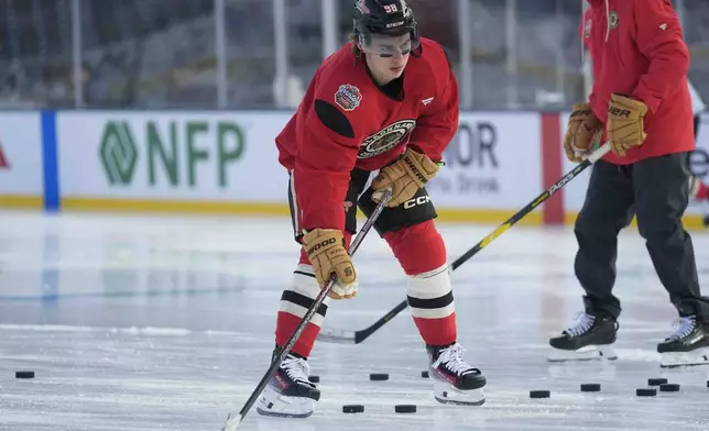 Chicago Blackhawks center Connor Bedard (98) skates during practice on the day before the NHL Winter Classic outdoor hockey game featuring the Blackhawks and the St. Louis Blues at Wrigley Field, Monday, Dec. 30, 2024, in Chicago. (AP Photo/Erin Hooley)