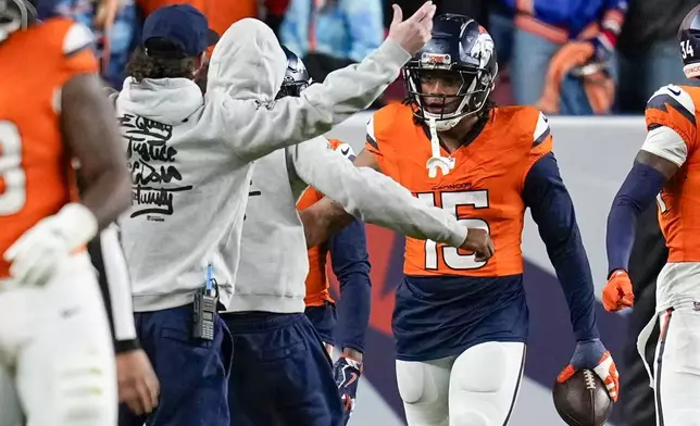 Denver Broncos' Nik Bonitto celebrates after returning an interception for a touchdown during the second half of an NFL football game against the Indianapolis Colts Sunday, Dec. 15, 2024, in Denver. (AP Photo/Jack Dempsey)