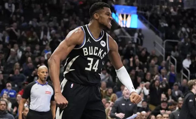 Milwaukee Bucks' Giannis Antetokounmpo reacts after a dunk during the second half of an Emirates NBA cup tournament quarterfinals basketball game against the Orlando Magic Tuesday, Dec. 10, 2024, in Milwaukee. (AP Photo/Morry Gash)