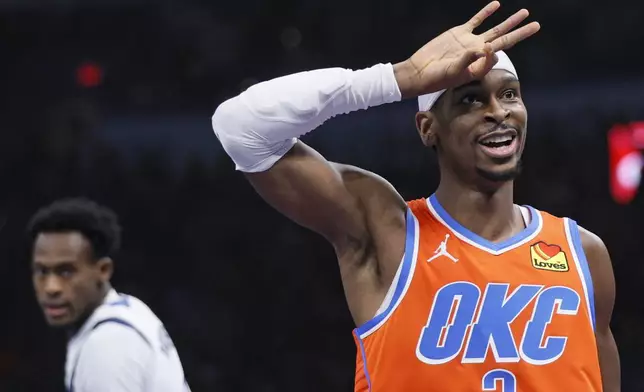 Oklahoma City Thunder guard Shai Gilgeous-Alexander gestures after making a 3-pointer during the first half of an Emirates NBA Cup basketball game against the Dallas Mavericks, Tuesday, Dec. 10, 2024, in Oklahoma City. (AP Photo/Nate Billings)