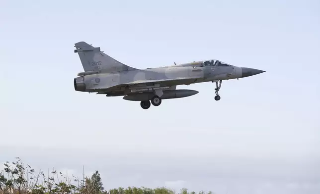 A Taiwan's fighter jet lands at an airbase in Hsinchu, northern Taiwan, Tuesday, Dec. 10, 2024, as Taiwan's Defense Ministry said it detected Chinese naval ships and military planes engaged in training. (AP Photo/Chiang Ying-ying)