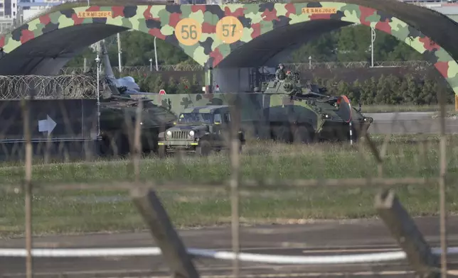 Taiwan army ground force members ride on vehicles at an airbase in Hsinchu, northern Taiwan, Tuesday, Dec. 10, 2024, as Taiwan's Defense Ministry said it detected Chinese naval ships and military planes engaged in training. (AP Photo/Chiang Ying-ying)