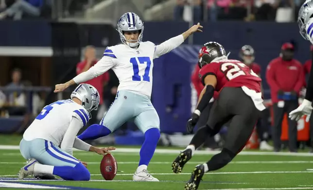 Dallas Cowboys place kicker Brandon Aubrey (17) kicks a field goal as punter Bryan Anger (5) holds, under pressure from Tampa Bay Buccaneers cornerback Zyon McCollum (27) in the first half of an NFL football game in Arlington, Texas, Sunday, Dec. 22, 2024. (AP Photo/Jeffrey McWhorter)