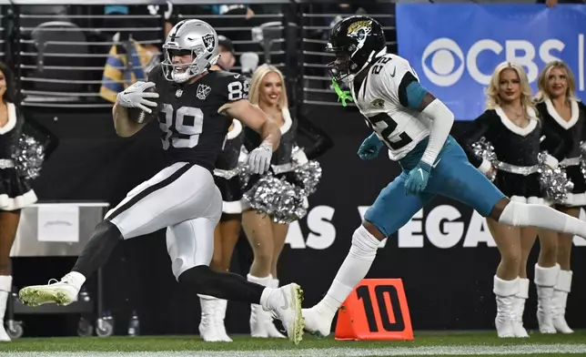 Las Vegas Raiders tight end Brock Bowers (89) runs with the ball against Jacksonville Jaguars cornerback Jarrian Jones (22) during the second half of an NFL football game Sunday, Dec. 22, 2024, in Las Vegas. (AP Photo/David Becker)