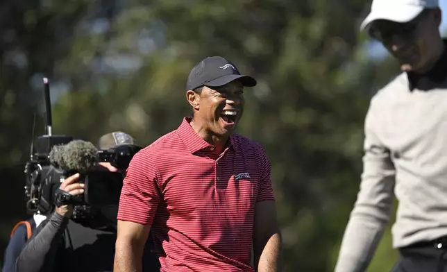 Tiger Woods, center, reacts to his son Charlie Wood's hole-in-one on the fourth hole during the final round of the PNC Championship golf tournament, Sunday, Dec. 22, 2024, in Orlando, Fla. (AP Photo/Phelan M. Ebenhack)