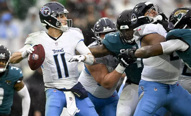 Tennessee Titans quarterback Mason Rudolph (11) looks throw a pass during the first half of an NFL football game against the Jacksonville Jaguars, Sunday, Dec. 29, 2024, in Jacksonville, Fla. (AP Photo/Phelan M. Ebenhack)